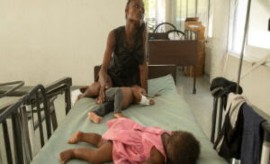 A one-year-old boy who is suffering from cholera is comforted by his mother at a hospital in Port-au-Prince, Haiti. (UN Photo)