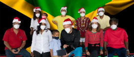 Consul General Oliver Mair (center right) accepting gift of a tablet from Little Joshua Dixon (center left) as contribution to the tablet and laptop educational drive to support Jamaican students. Looking on are committee members of the upcoming Virtual Christmas Concert/Telethon on Sunday, Dec. 20.