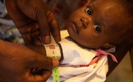A young child is screened for malnutrition in Cité Soleil, Haiti. Photo: UNICEF