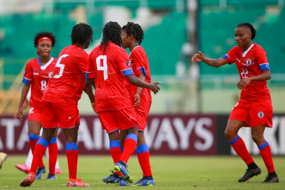 Rosellor Borgella (right) of Haiti celebrates with her teammates after scoring four goals in a victory against St. Vincent and the Grenadines in Cuba on Sunday. (Photo: CONCACAF)
