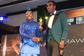 Jamaican dancehall artist Spice winning an IRAWMA award in 2019.