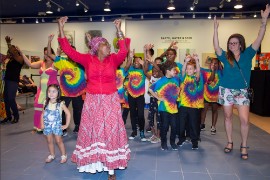 Queen” Maxine Osbourne leads kids in a cultural dance performance at Island SPACE Caribbean Museum. Photo by Eric Greaves