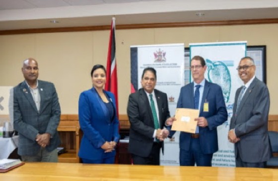 Energy Minister Dr Roodal Moonilal, third from left, hands over the Certificate of Environmental Clearance (CEC) to local advisor Alex Almandoz, the in-country representative for ExxonMobil on Monday.