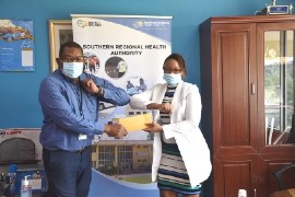 SRHA Regional Director, Michael Bent presents the cheque from Ms. Beverly Nichols to SRHA Regional Medical Epidemiologist, Dr. Fatoumata Fadji Sylla- Roberts (right).