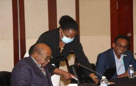 Hon. Edmund Bartlett, Minister of Tourism (left) in discussion with Jennifer Griffith, Permanent Secretary in the Ministry of Tourism, during a meeting of the board of the Tourism Enhancement Fund (TEF). Looking on is Dr. Carey Wallace, TEF Executive Director.