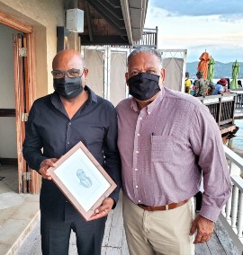 USVI Commissioner of Tourism Joseph Boschulte (right) presented a portrait to and exchanged ideas with Jamaica's Minister of Tourism Edmund Bartlett in Jamaica last week.