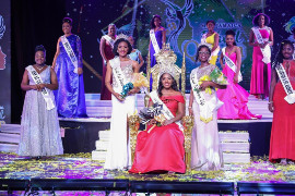 Freshly-crowned Miss Jamaica Festival Queen 2021 Dr. Dominque Reid who represented the parish of Manchester (center) shares the winning stage with First Runner Up - Miss Westmoreland Nakinskie Robinson (center left) and Second Runner Up - Miss St. James Morganne Kellier (center right), and the other ten Parish Queens who were finalists in the competition, during the televised Independence Grand Coronation last August.