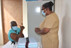 Senior Medical Officer at the Mandeville Regional Hospital, Dr. Everton McIntosh (left) is in great spirits after being the first person to receive the COVID-19 vaccine in Manchester. The vaccine was administered by Public Health Nurse at the Manchester Health Department, Maxine Isaacs.