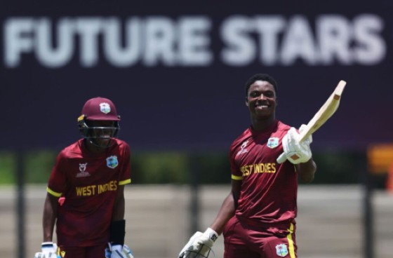 Shamar Apple (right) celebrates his century against Japan, while Tanez Francis (left), who also scored a hundred looks on. (Photo by Matthew Lewis-ICC/ICC via Getty Images)