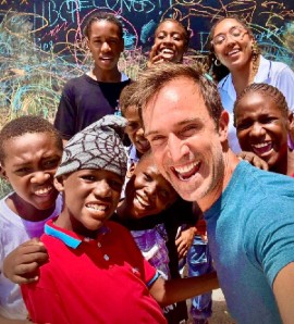 Zay Harding and GraceKennedy Foundation's Jade Ashley Carberry (far right, back row) with children from the Rose Town community in Kingston during filming of The Visioneers with Zay Harding. (PHOTO CREDIT: Zay Harding)