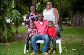 New Habitat homeowners Gerald and Kathiana Charles with sons Gianni and Giovanni; and Gerald's mother, Marvelia Charles (top left)