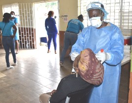 Senior Public Health Nurse at the Manchester Health Department, Carlette Thompson, conducts a COVID-19 test on a resident in Chudleigh in Manchester on Thursday, February 4.