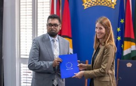 President Irfaan Ali and Deputy Secretary General of European Union Action Service, Helena Konig show off the agreement (DPI Photo)