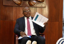Minister of Housing, Urban Renewal, Environment and Climate Change Pearnel Charles Jr, with a copy of the draft National Housing Policy.