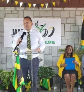 Jamaica’s Consul General in Miami Mr., Oliver Mair delivering the message from Minister of Culture, Gender, Entertainment and Sports The Hon. Olivia Grange at the Atlanta launch of Jamaica-60 celebration activities. Seated is Jamaica’s honorary consul in Atlanta Dr. Elaine Bryan.