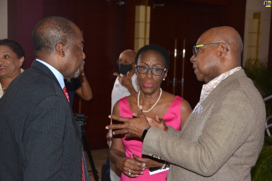 Minister of Tourism, Hon. Edmund Bartlett (right), speaks with President of the Jamaica Hotel and Tourist Association (JHTA), Clifton Reader, and Director of the Jamaica Centre of Tourism Innovation, Carol Rose Brown, during the launch ceremony of the JCTI’s Database of Certified Individuals, held at the Montego Bay Convention Centre in Rose Hall on Friday, October 21. (Photo by Okoye Henry via JIS)