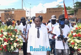 Jimmy Chérizier, alias “Barbecue,” surrounded by armed gunmen in street procession to lay flowers honoring Jean-Jacques Dessalines (Le Nouvelliste Photo)