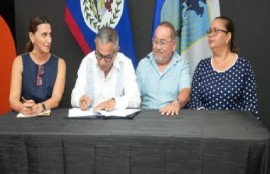 Prime Minister John Minister John Briceño signing the agreement