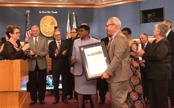 MIA Director Lester Sola accepts a proclamation from the County Commission on MIA’s passenger traffic milestone.