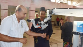 Consultant at the MRH ENT department, Dr. Andrew Manning (left) demonstrates the use of the surgical microscope to Acting CEO of the MRH, Marcia Francis.