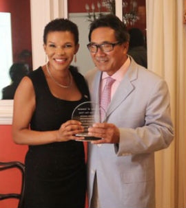 Doctor Paul Chen-Young accepts a plaque from Jamaican Ambassador to the United States Her Excellency Audrey Marks.