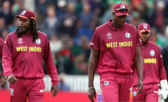 Captain Jason Holder, forefront, and his team will take a pay cut