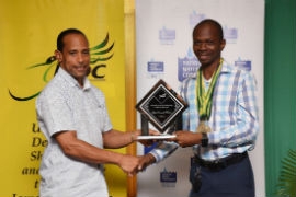Best Overall Writer in the 2019 Jamaica Creative Writing Competition,Rohan Facey (right) receives his award from Kenneth Shaw, JCDC Board Commissioner at the competition’s 2019 award ceremony, held in August.
