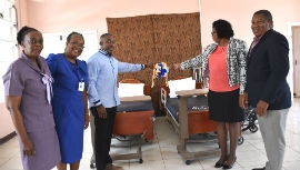 CEO of the Lionel Town Hospital (LTH), Nadine Preddie (2nd right) along with donor, Dr. Everton Fider (3rd left) cut the ribbon to display some of the hospital supplies which were donated. Also photographed are: Regional Director of the Southern Regional Health Authority, Michael Bent (right), Senior Medical Officer at the LTH, Dr. Darsie Haughton (right) and Director of Nursing Services at the LTH, Nichola Fowler-Higgins.