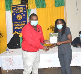 Regional Director for the SRHA, Michael Bent (left) presents an award for 21 years of outstanding service to Nurse Anaesthetist at the PJH, Vivienne Bailey Hinds.