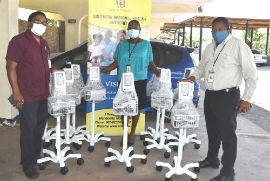 Regional Director for the SRHA, Michael Bent (right), CEO of the Mandeville Regional Hospital, Alwyn Miller (left) and Director  of Public Procurement at the SRHA, Stacey-Ann Edwards are pictured here with the 10 vital sign machines.