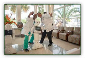 Two JTCHS physicians pose for a selfie with Pepper. 