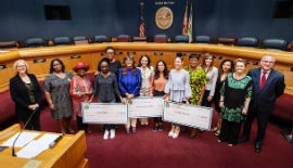 County Commission Chairwoman Audrey Edmonson, Vice Chairwoman Rebeca Sosa, Commissioner Eileen Higgins, and Commissioner Esteban Bovo, Jr., along with Commission for Women members, present the Young Women Achiever scholarship checks.  (Photo by Ryan Holloway/Miami-Dade County)