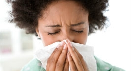 Sneezing is one way the virus is passed on.