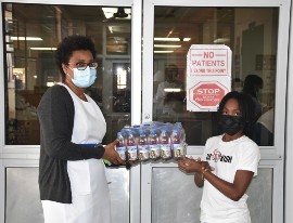 Lil Kish is seen here with Ward Manager for the Isolation Ward at the Mandeville Regional Hospital, Rhodell Morris Knott after she donated cases of juice and water to the staff members on Friday., February 12.