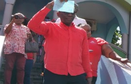Prime Minister Phillip J Pierre shows off his nomination paper to contest the Castries East seat he has represented since 1997 (CMC Photo)
