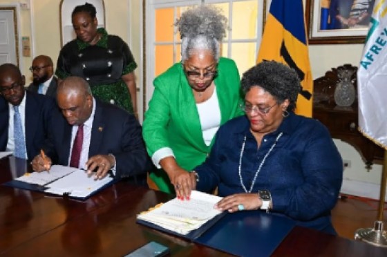 Chairman of Afreximbank Professor Benedict Oramah and Prime Minister Mia Mottley signing the loan agreement.