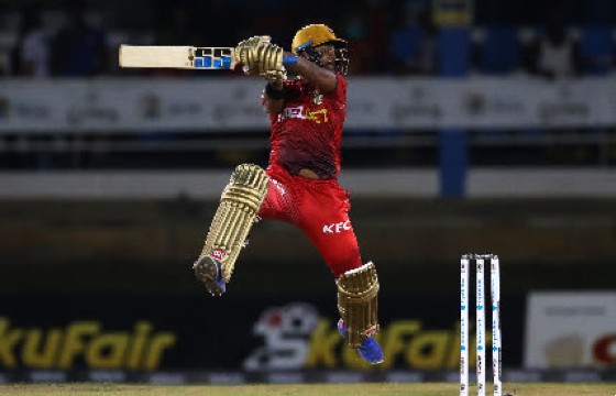 Left-hander Nicholas Pooran goes airborne as he hits through the off side during his unbeaten 102 on Wednesday night. (Photo courtesy CPLT20/Getty Images)