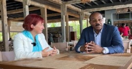 Prime Minister Gaston Browne discussing the launch of the project with an official from the reef restoration project OceanShot (CMC Photo)