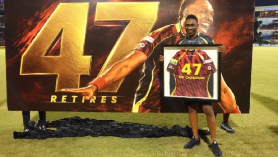Dwayne Bravo poses with a picture of his retired number 47 jersey during the ceremony on Saturday.