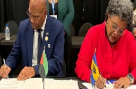 Barbados Prime Minister Mia Mottley and president of the Territorial Collectivity of Martinique, Serge Letchimy, signing. cooperation agreement