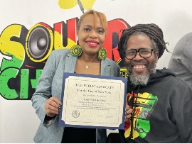 Sound Chat Radio Founder Garfield “Chin” Bourne receives a citation from the Office of NYC Public Advocate Jumaane Williams (represented by Sabine French).