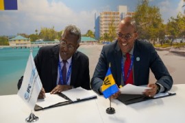 Mohamed Gouled, IFC’s Vice President of Industries. and Kerrie Symmonds, Minister of Foreign Affairs and Foreign Trade of Barbados. sign the agreement (IFC Photo)