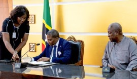 Prime Minister Dr. Terrance Drew, who is on an official visit to Ghana, signs the visa waiver agreement