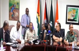Home Affairs Minister, Oneidge Walron (center) with members of the police and military at the joint press conference on Tuesday evening