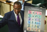 Minister of Finance and the Public Service, Dr. Nigel Clarke, displays the new/upgraded banknotes, which will go into circulation later this year. (Photo: JIS)